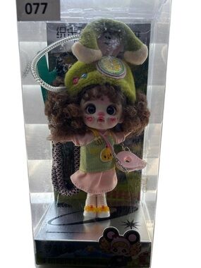 Cute Curly-Haired Doll with Green Bunny Hat and Pink Outfit